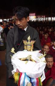Tibetan man waiting in line with an idol at the 2003 Kalachakra Initiation, Bodhgaya.