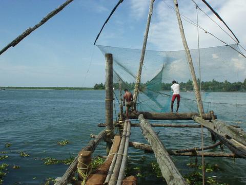 Men working on the cantilevered Chinese fishing nets, Fort Cochin, Kerala.