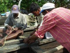 Men repairing fishing nets, Fort Cochin.