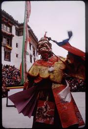 Monk in red-faced mask (perhaps representing the god Pektse?) at the winter festival at the Spituk Gompa, just outside of Leh in Ladakh, northern India.