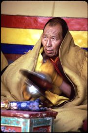 Monk playing Tibetan cymbals (rolmo), at the Spituk monastery winter festival.
