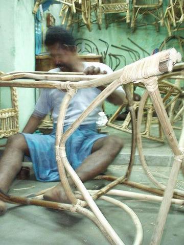 Man bending wicker to make a chair, Madurai.